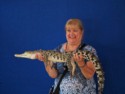 Linda bravely holds a small crocodile